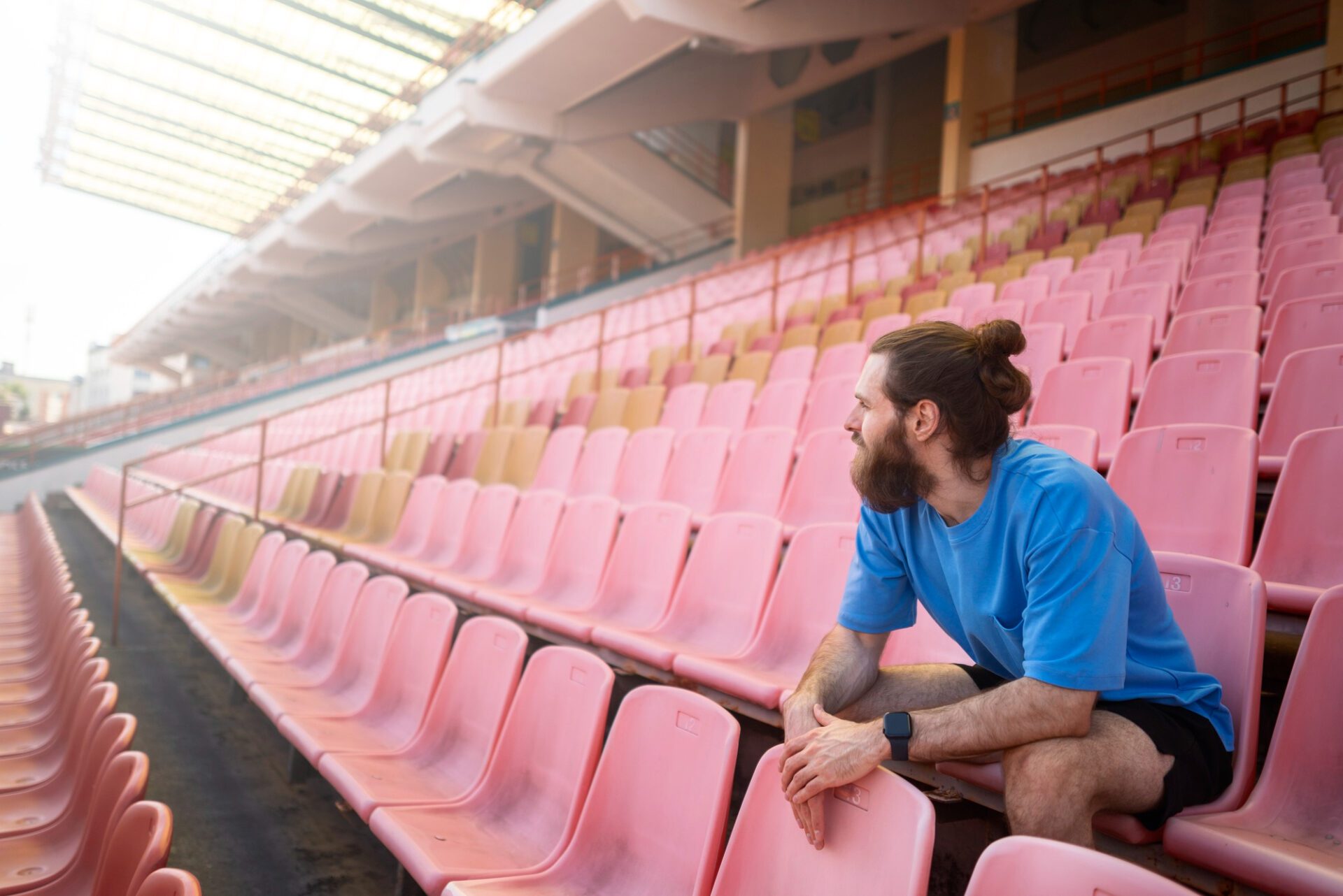 Full shot man sitting on grandstands